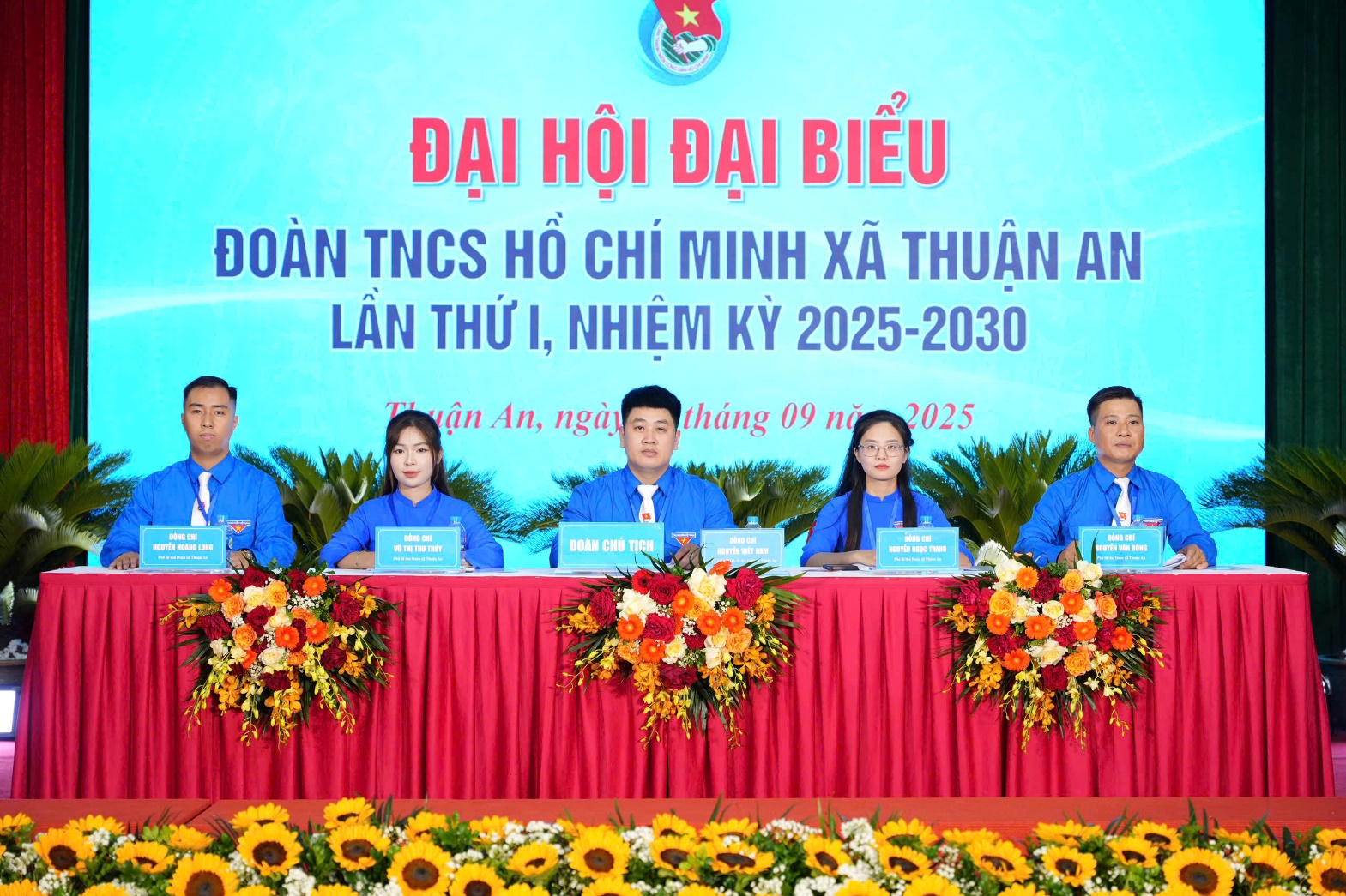 A group of people sitting at a table with flowers  AI-generated content may be incorrect.