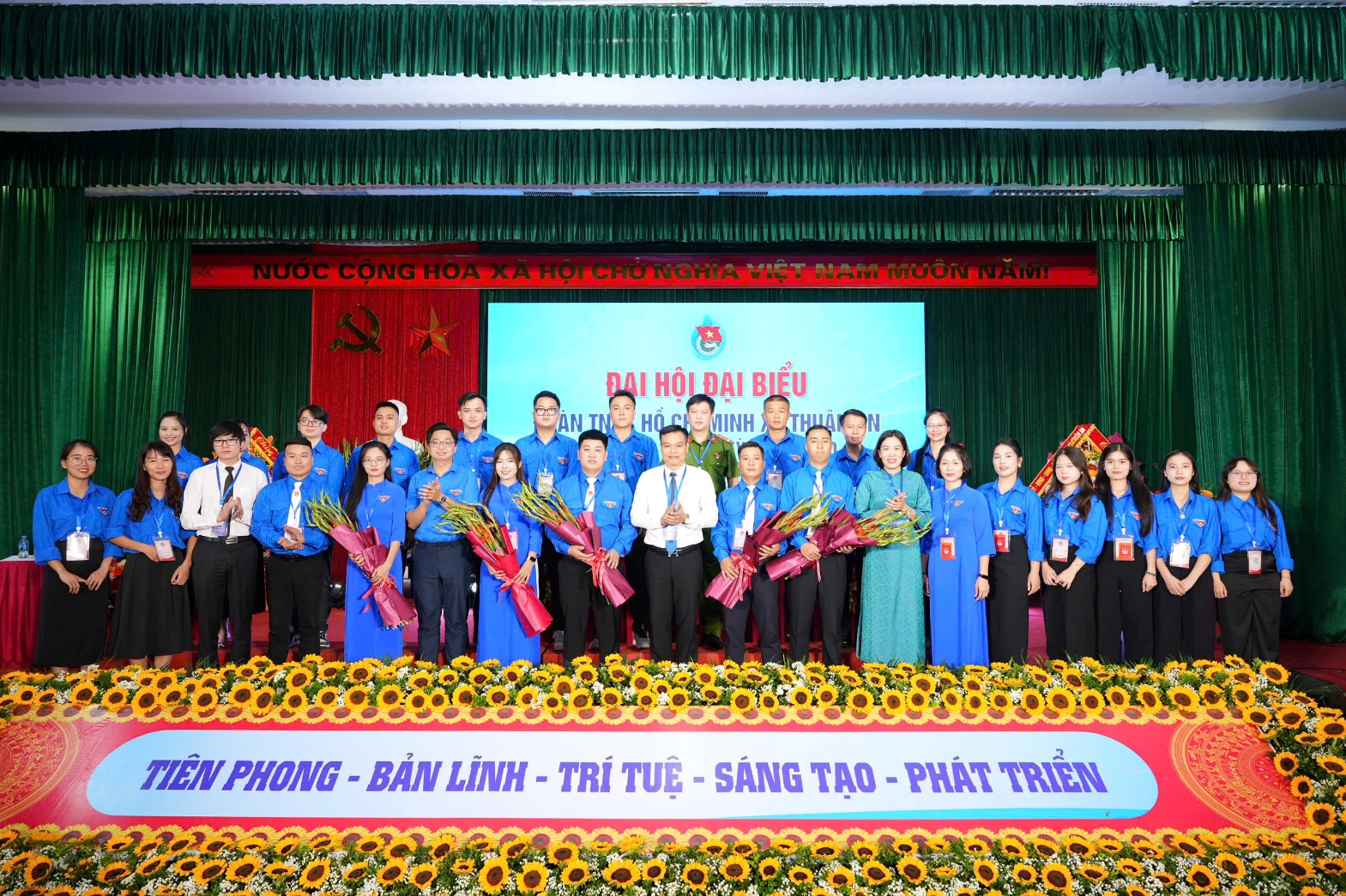 A group of people standing on a stage  AI-generated content may be incorrect.