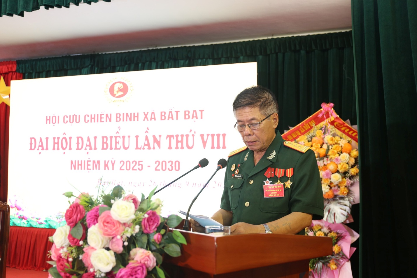 A person in uniform standing at a podium  Description automatically generated