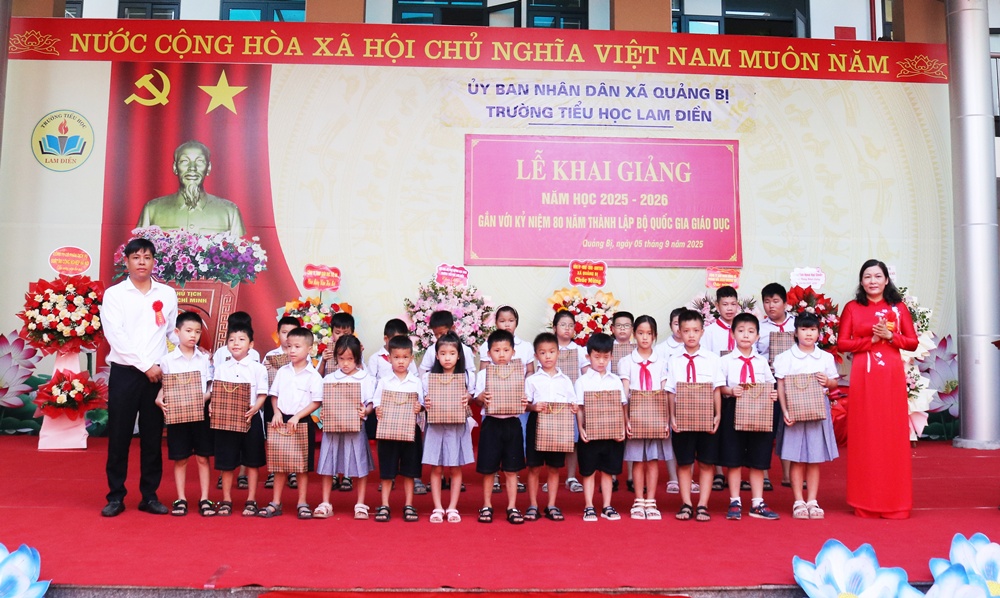 A group of children standing in front of a banner  AI-generated content may be incorrect.