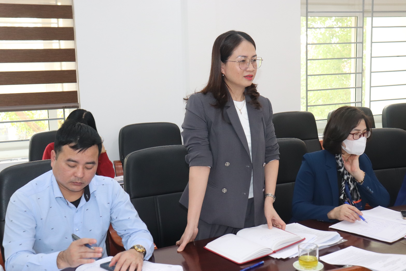 A person standing next to a group of people  AI-generated content may be incorrect.