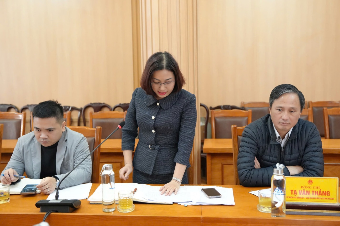 A person standing behind a person at a table  AI-generated content may be incorrect.