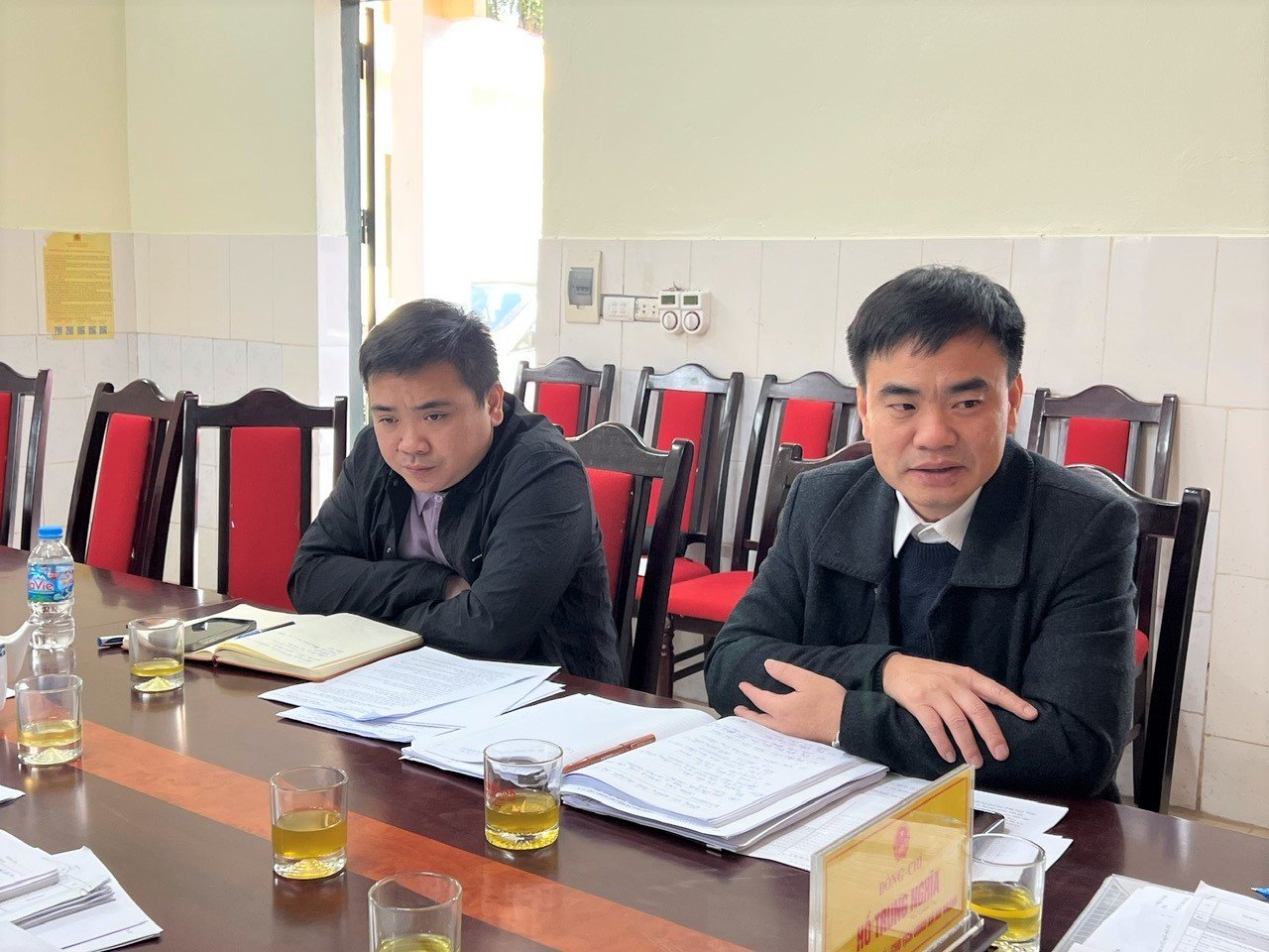 A group of men sitting at a table  AI-generated content may be incorrect.