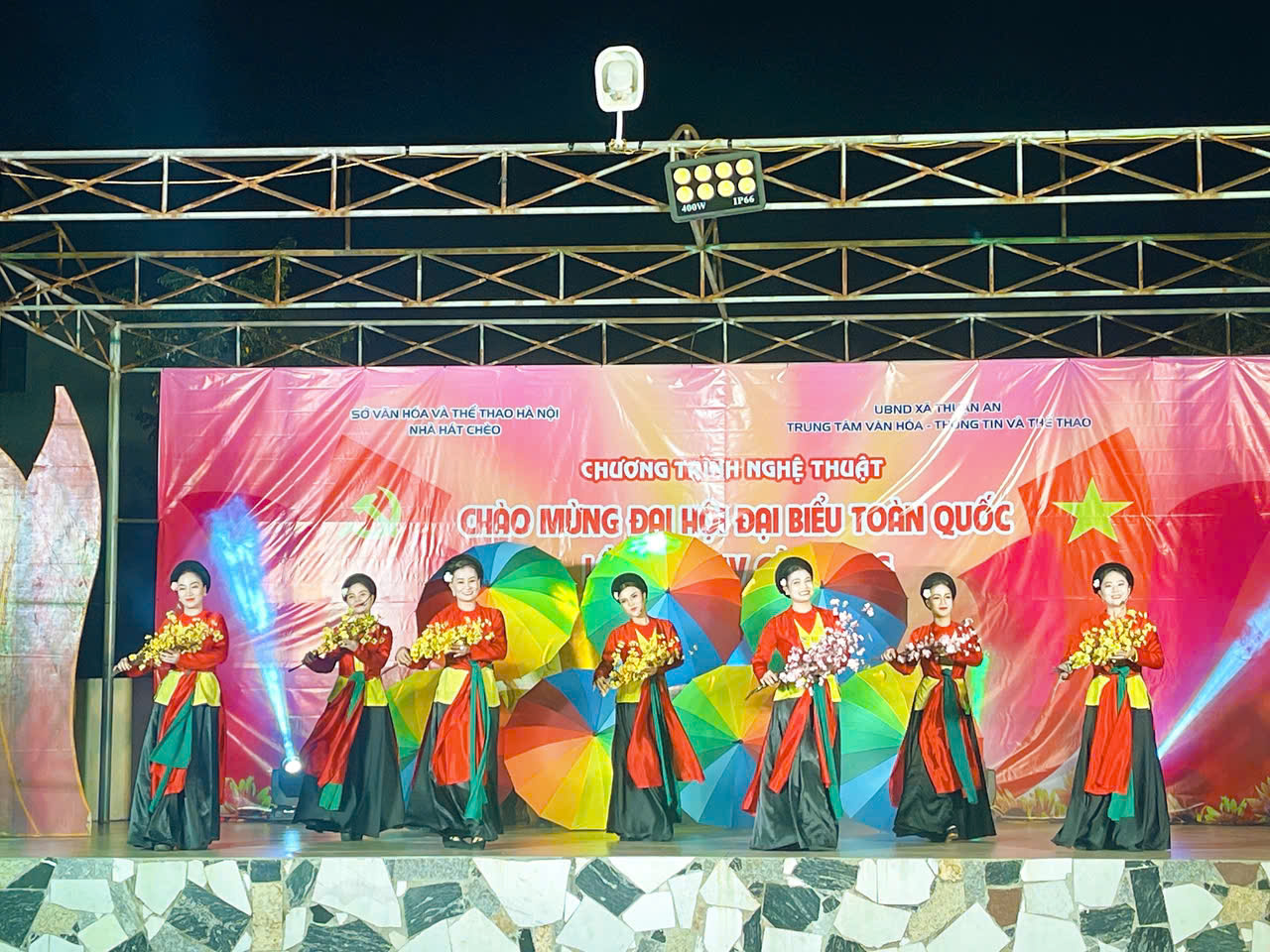 A group of women performing on a stage  AI-generated content may be incorrect.