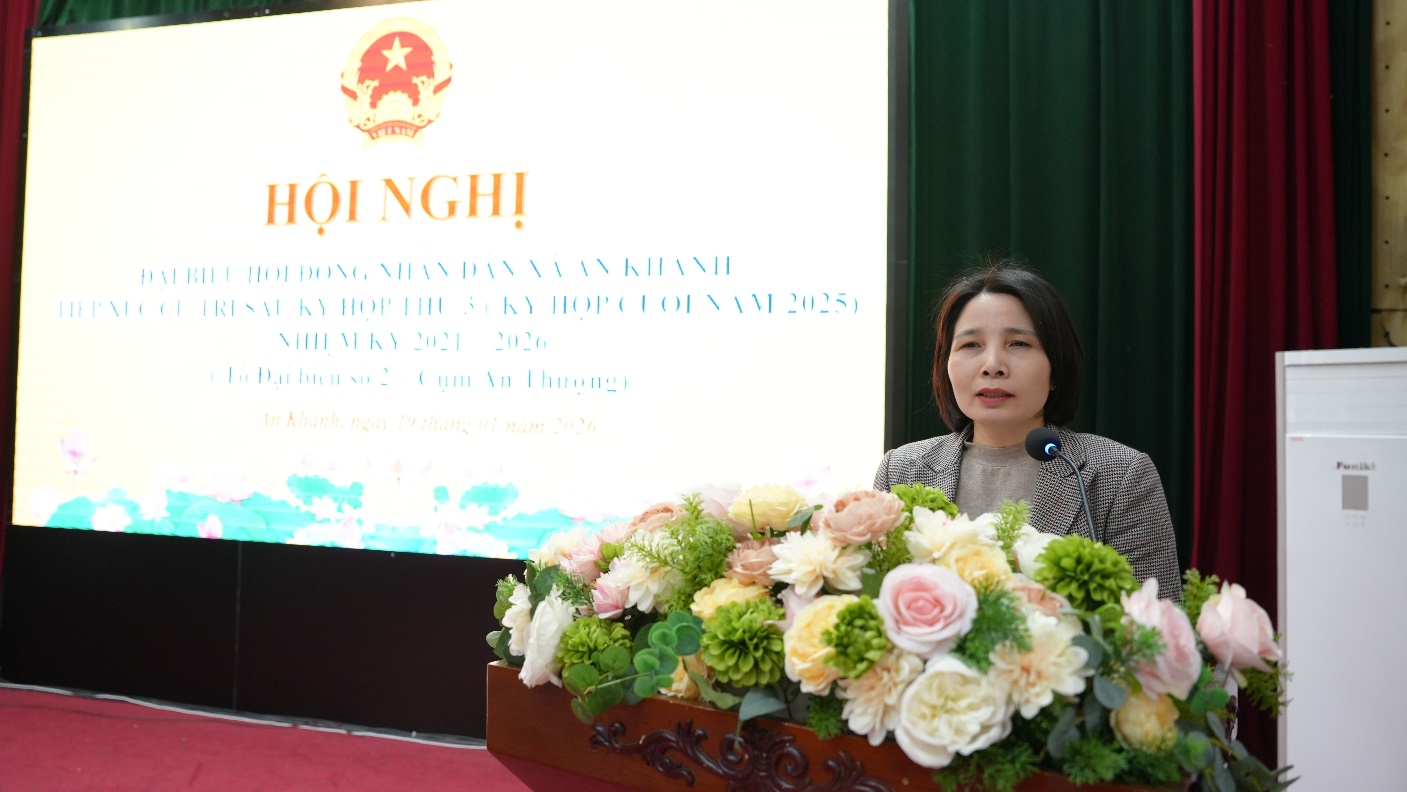 A person standing behind a podium with flowers  AI-generated content may be incorrect.