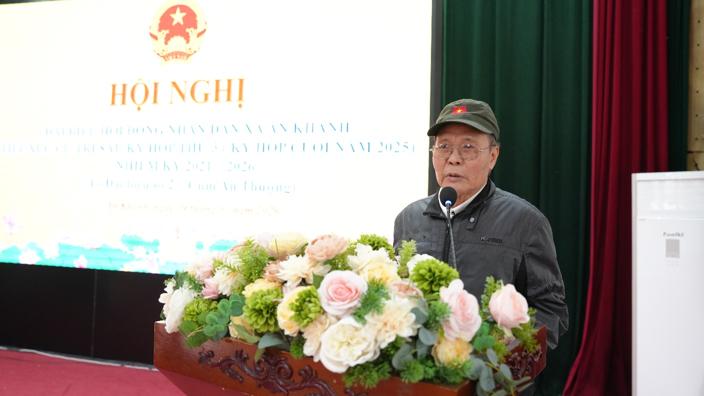 A person standing at a podium with a microphone and flowers  AI-generated content may be incorrect.