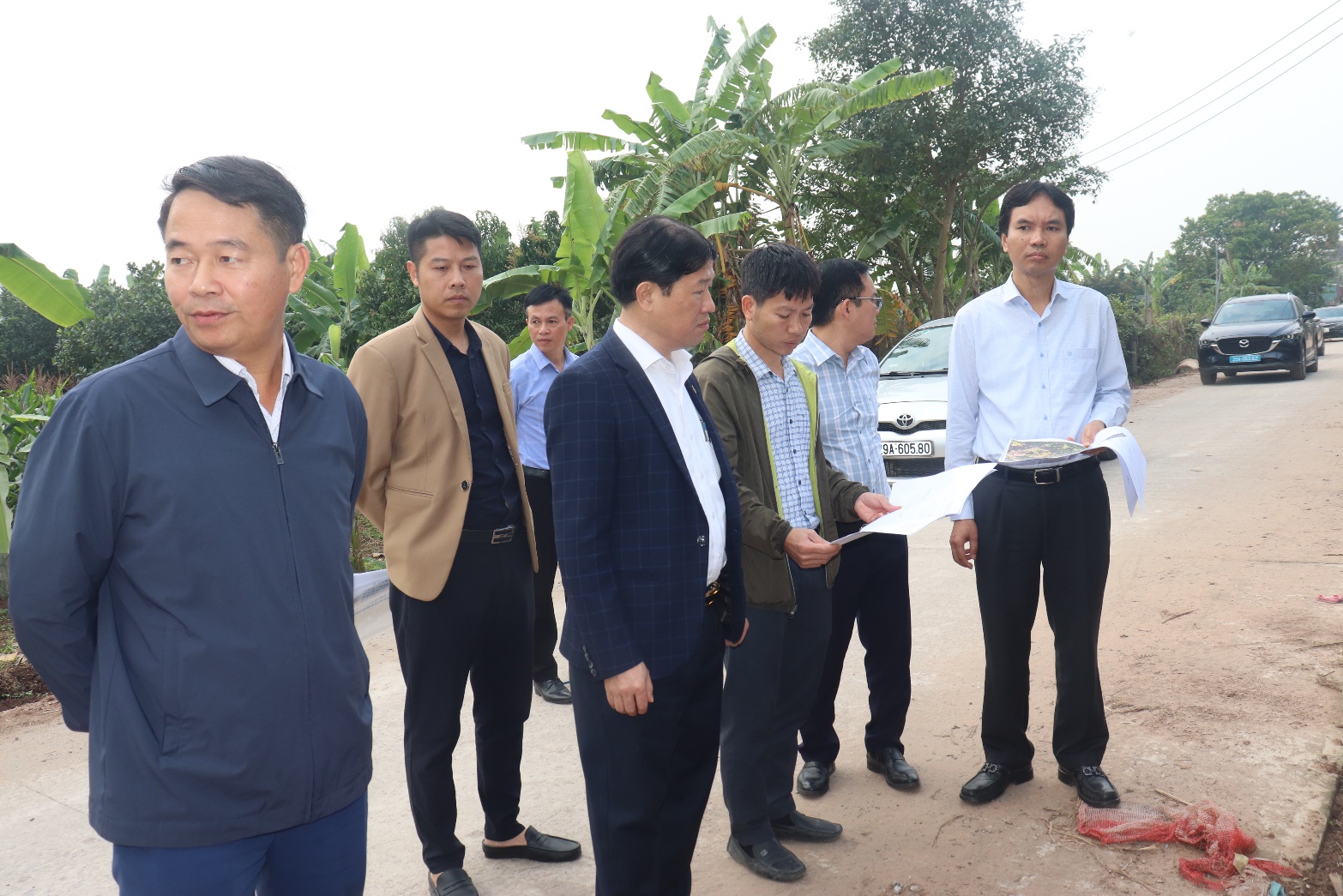 A group of men standing outside  AI-generated content may be incorrect.