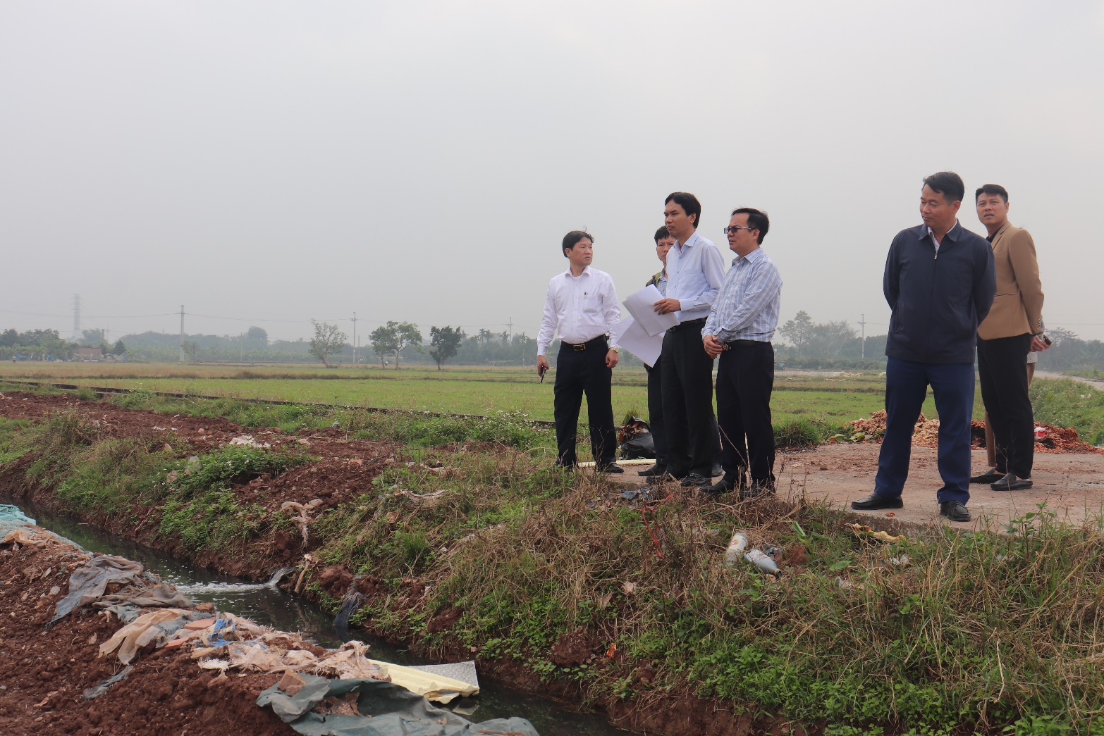A group of men standing in a field  AI-generated content may be incorrect.