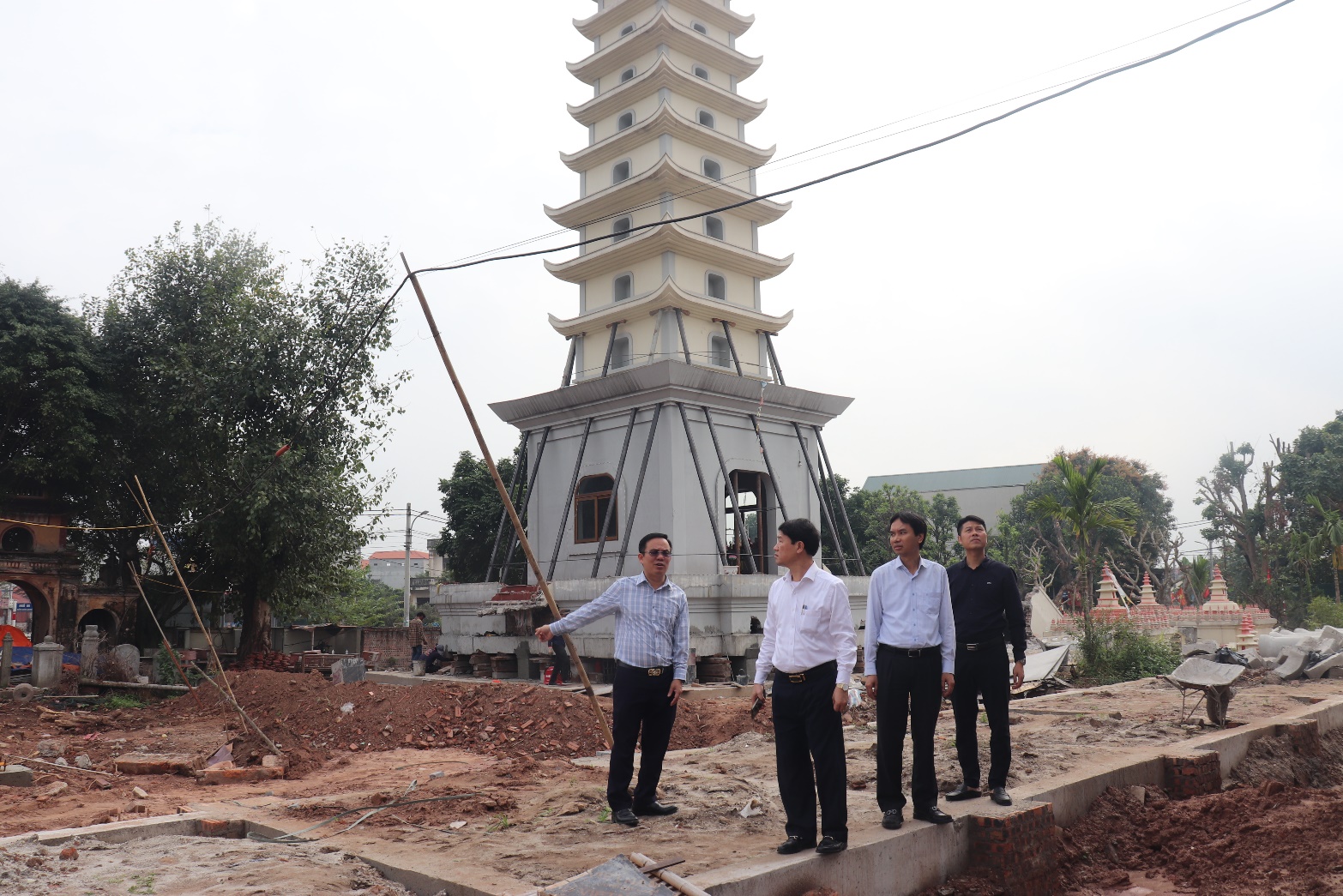 A group of men standing in front of a tower  AI-generated content may be incorrect.
