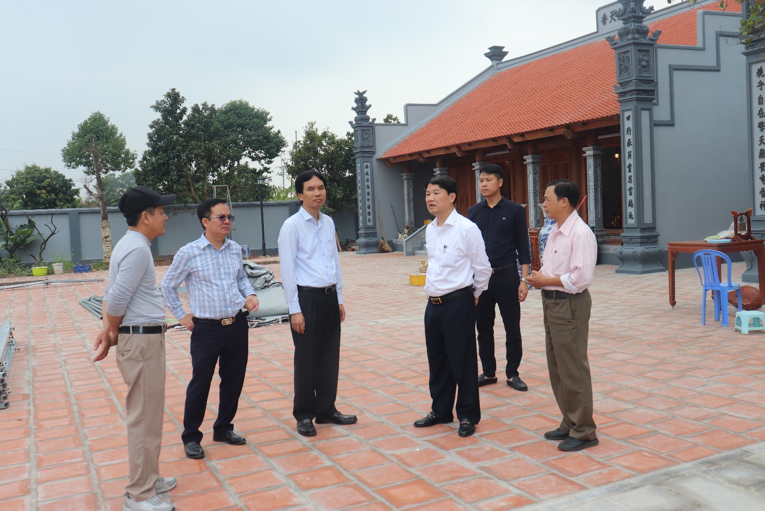 A group of men standing outside  AI-generated content may be incorrect.