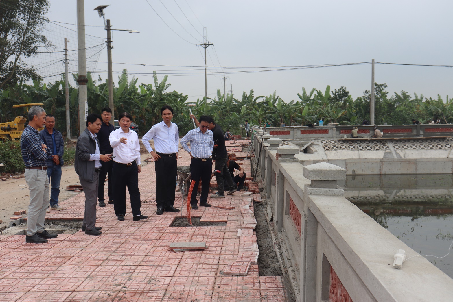 A group of men standing on a brick walkway  AI-generated content may be incorrect.