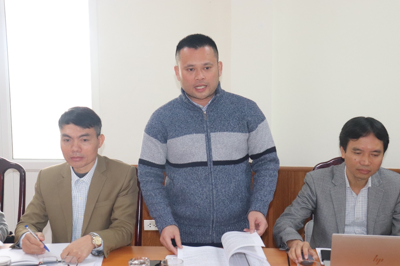 A group of men sitting at a table  AI-generated content may be incorrect.