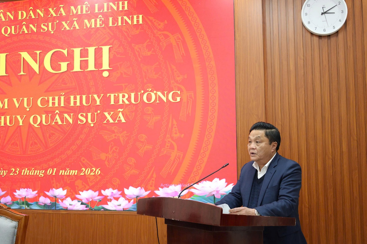 A person standing at a podium  AI-generated content may be incorrect.