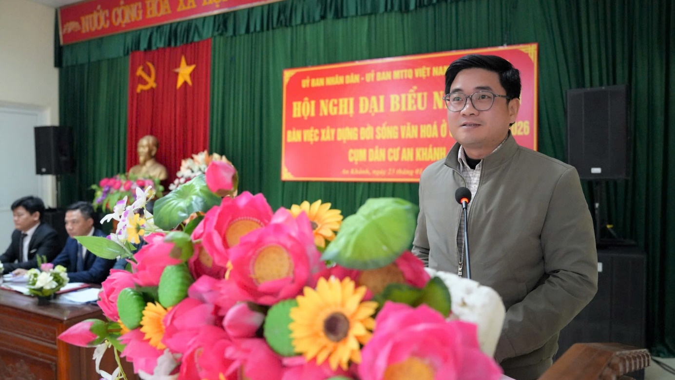 A person standing in front of a podium with a microphone and flowers  AI-generated content may be incorrect.