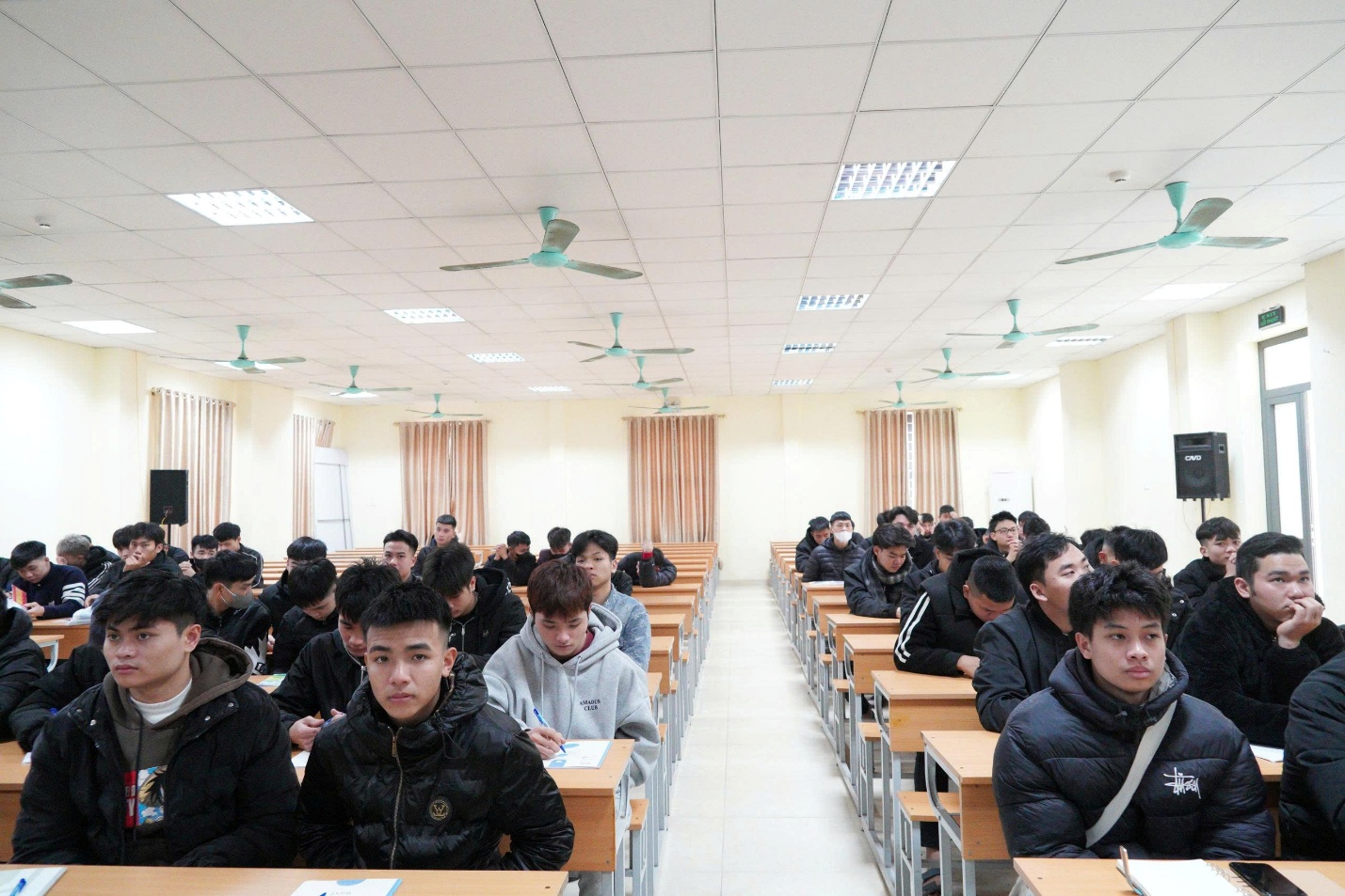 A group of people sitting in a classroom  AI-generated content may be incorrect.