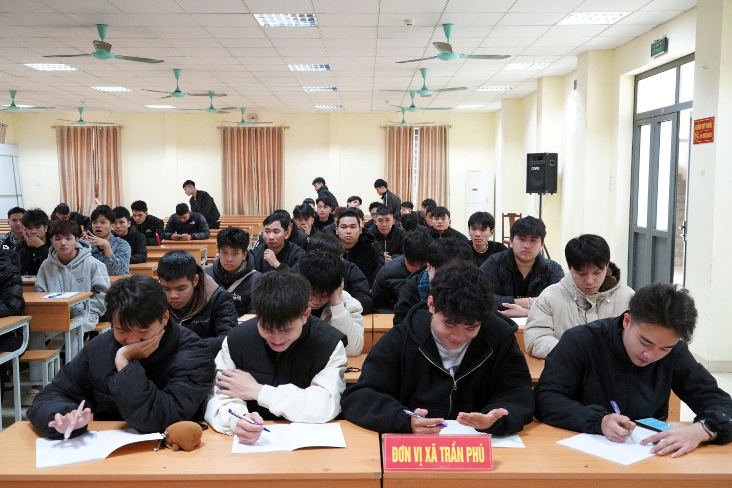 A group of people sitting at desks in a classroom  AI-generated content may be incorrect.