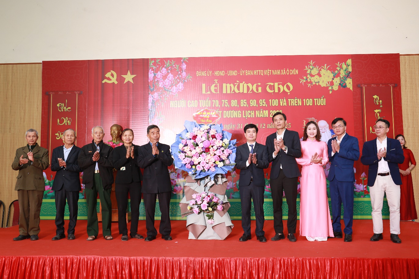 A group of people standing on a stage  Description automatically generated