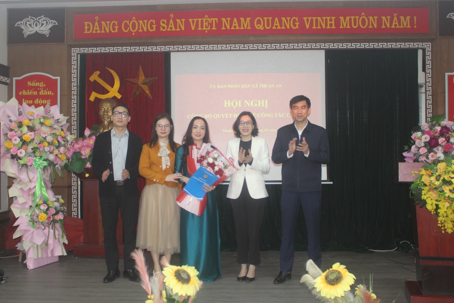 A group of people standing on a stage  AI-generated content may be incorrect.