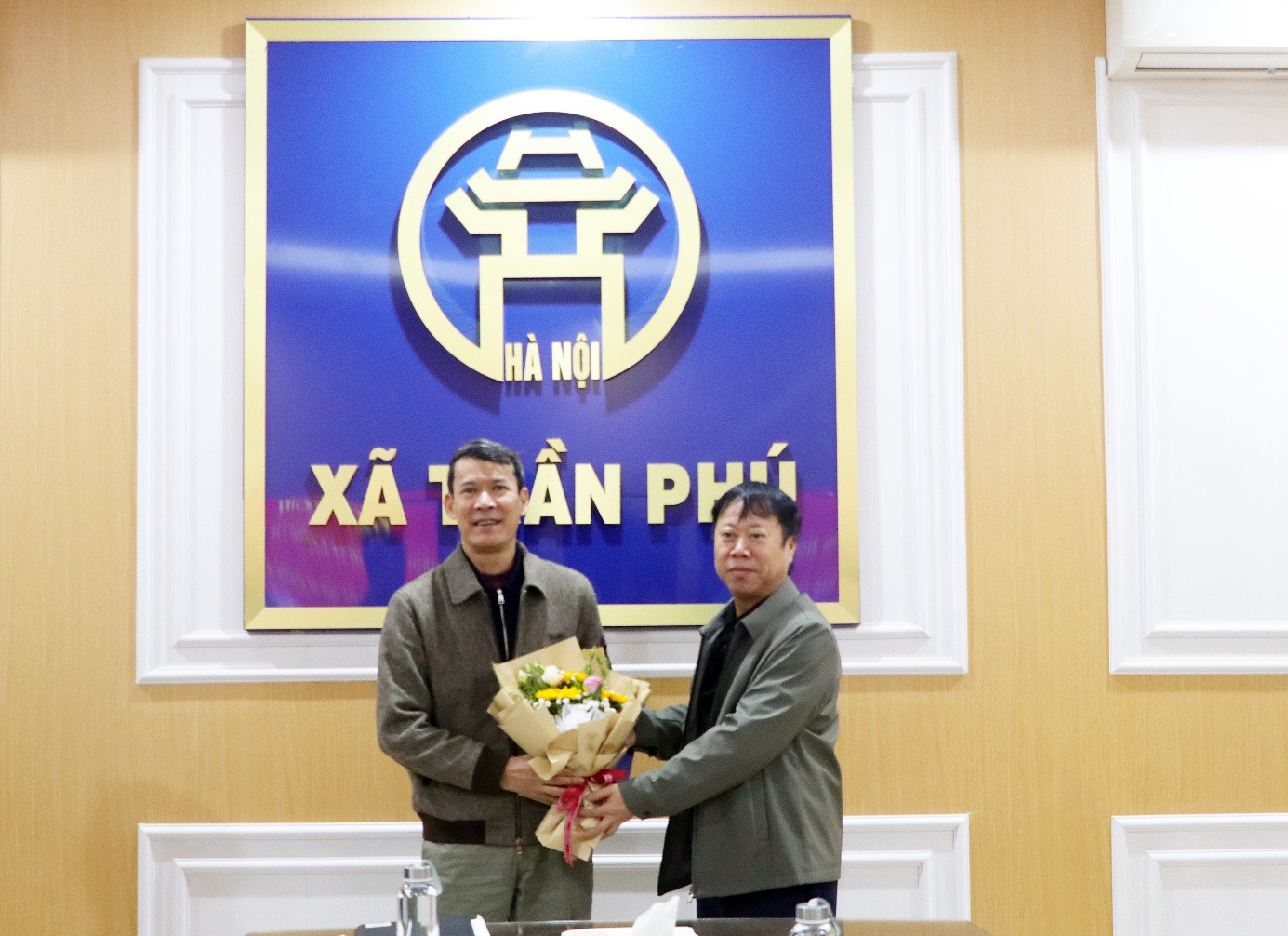 A couple of men standing in front of a sign  AI-generated content may be incorrect.