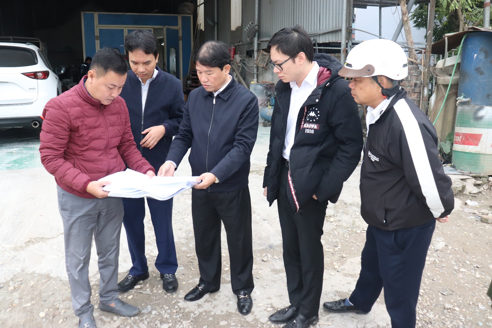 A group of men looking at a piece of paper  AI-generated content may be incorrect.