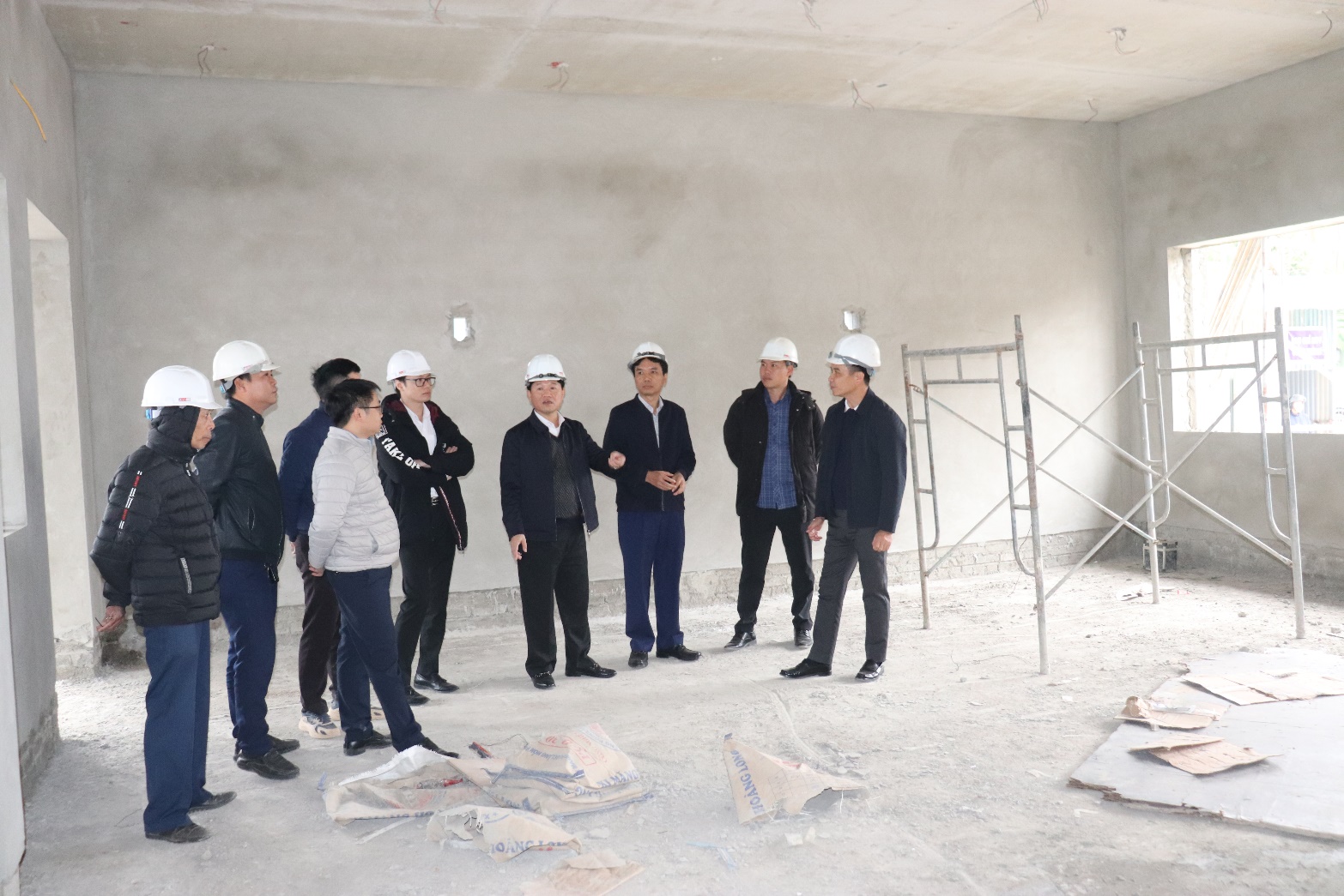 A group of men wearing hard hats  AI-generated content may be incorrect.