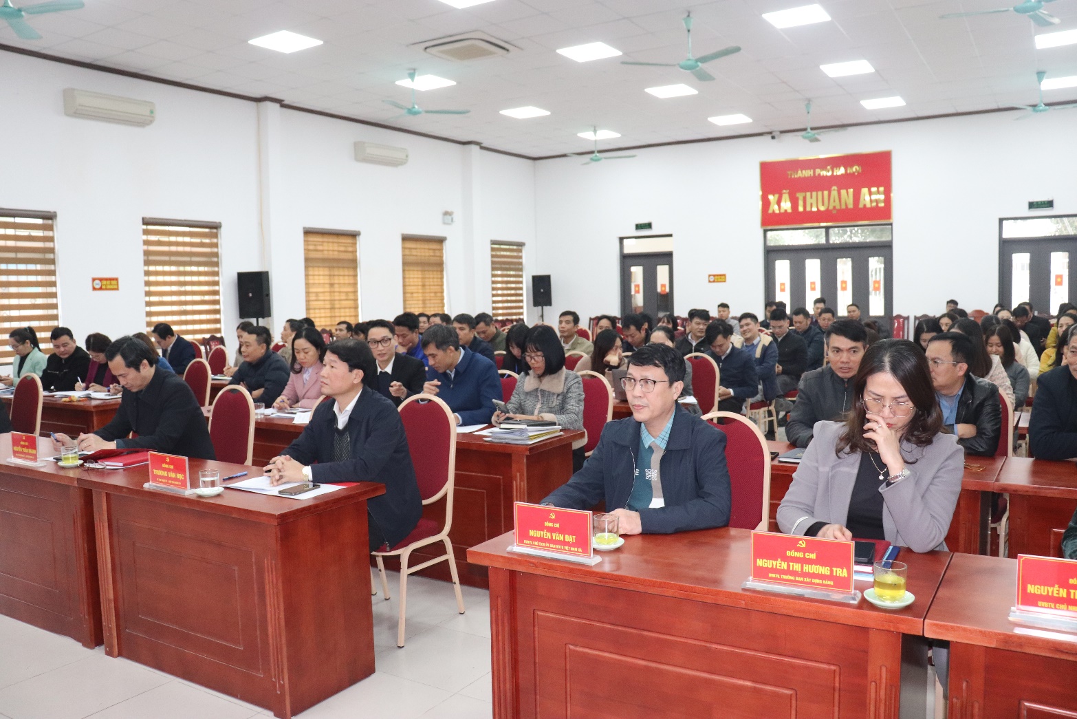 A group of people sitting at desks in a room  AI-generated content may be incorrect.