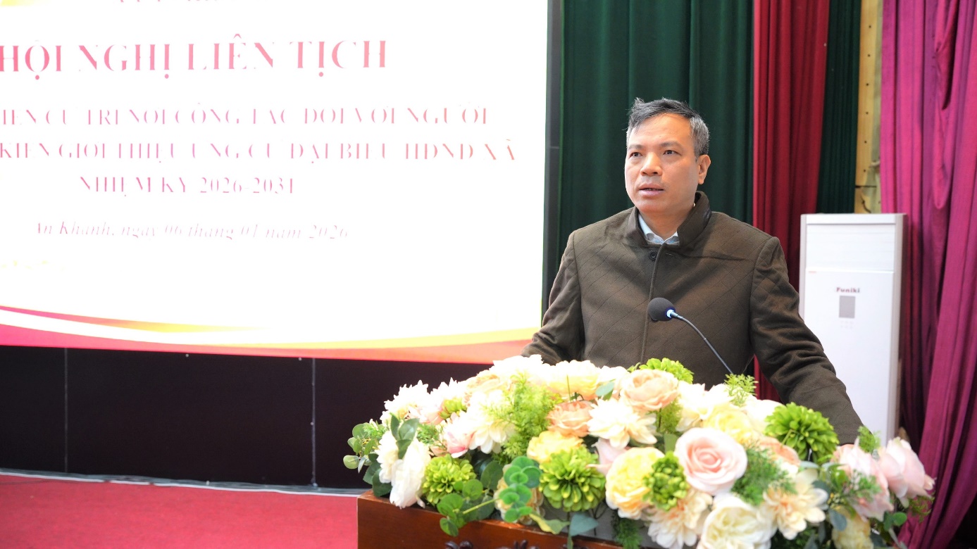 A person standing at a podium with a microphone and flowers  AI-generated content may be incorrect.