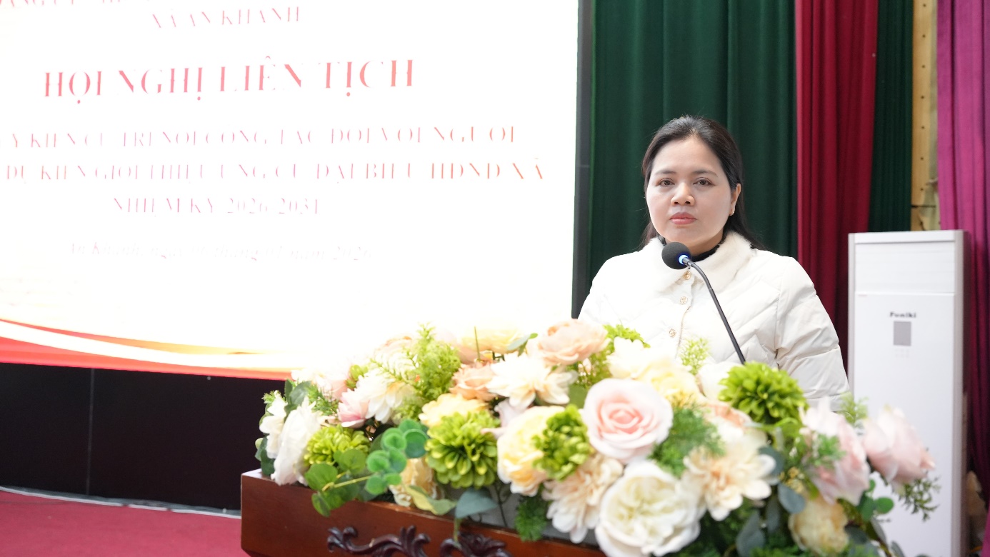 A person standing at a podium with a microphone  AI-generated content may be incorrect.