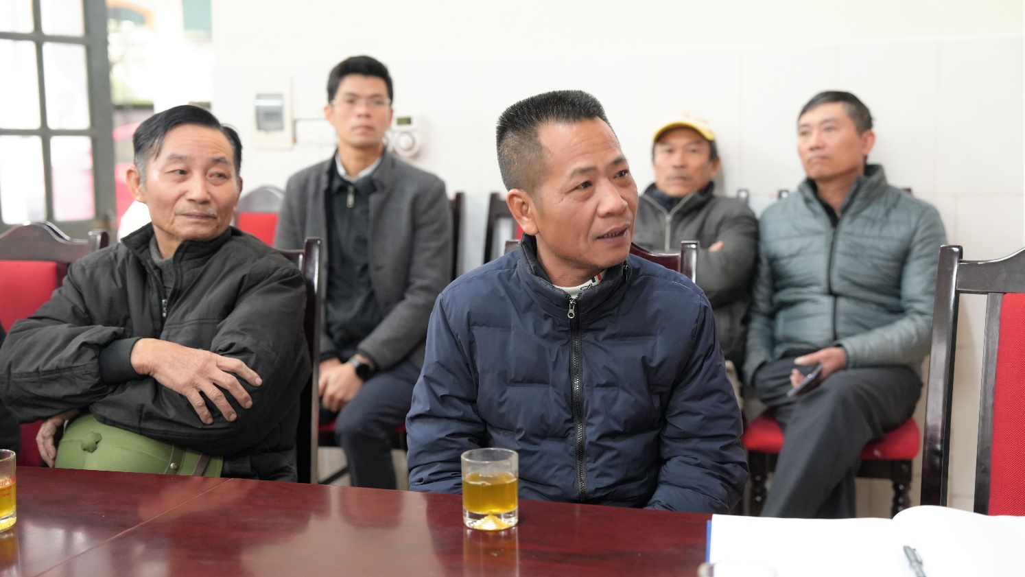 A group of people sitting at a table  AI-generated content may be incorrect.