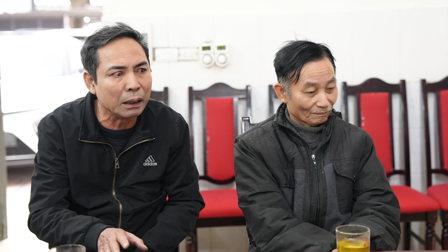 A couple of men sitting at a table  AI-generated content may be incorrect.