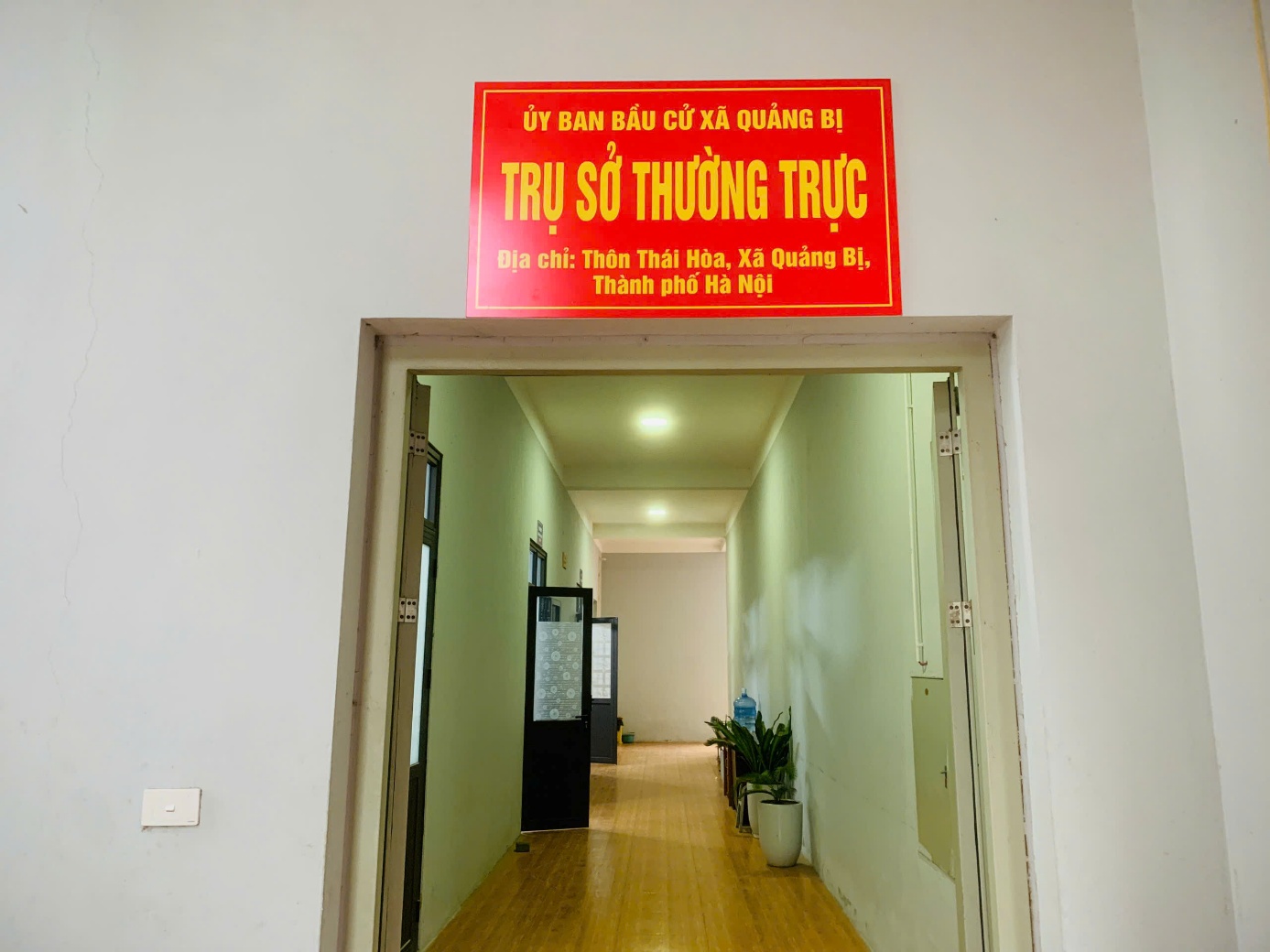 A hallway with a sign above the door  AI-generated content may be incorrect.