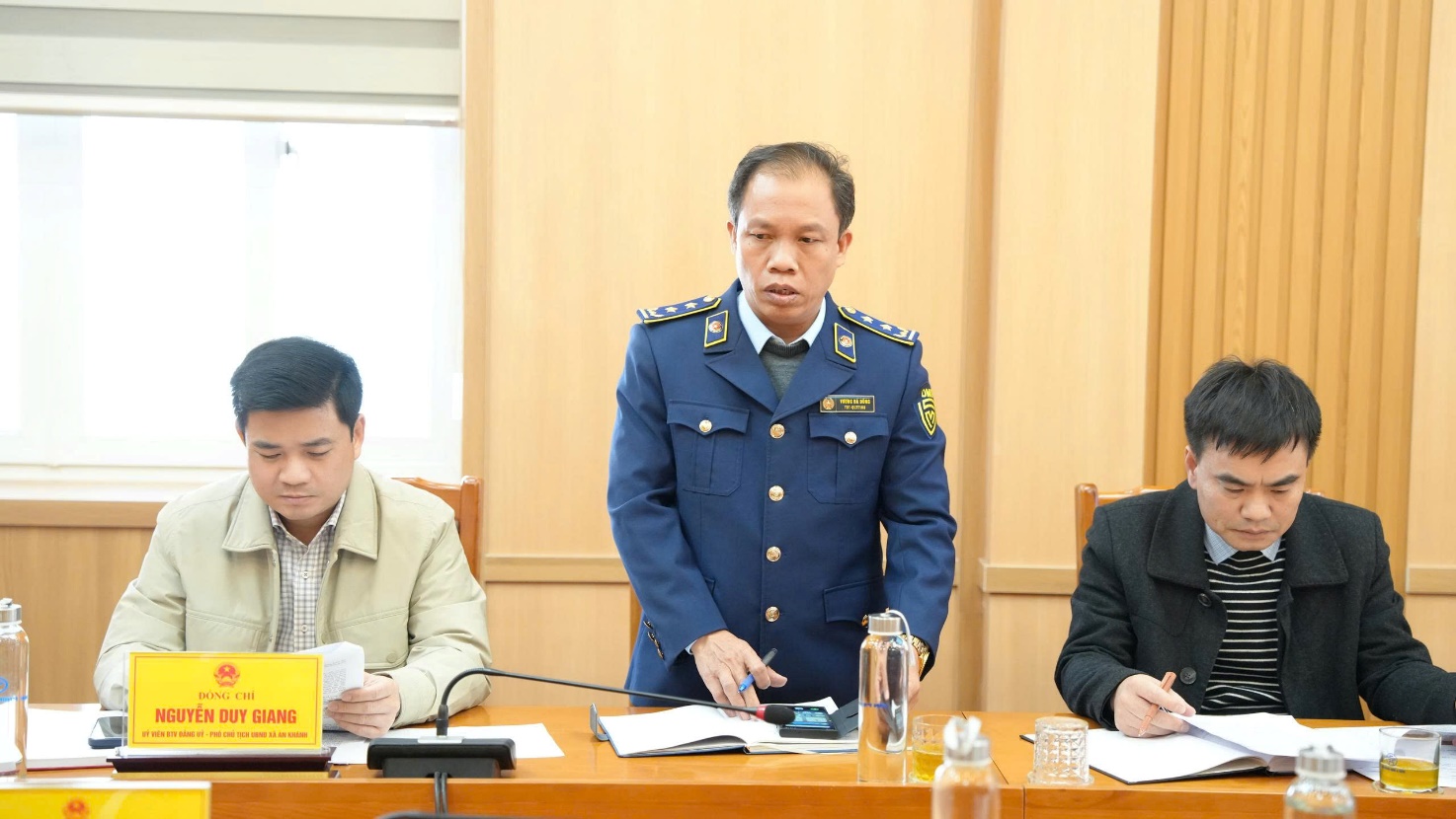 A person in a blue uniform standing behind a table with other men  AI-generated content may be incorrect.