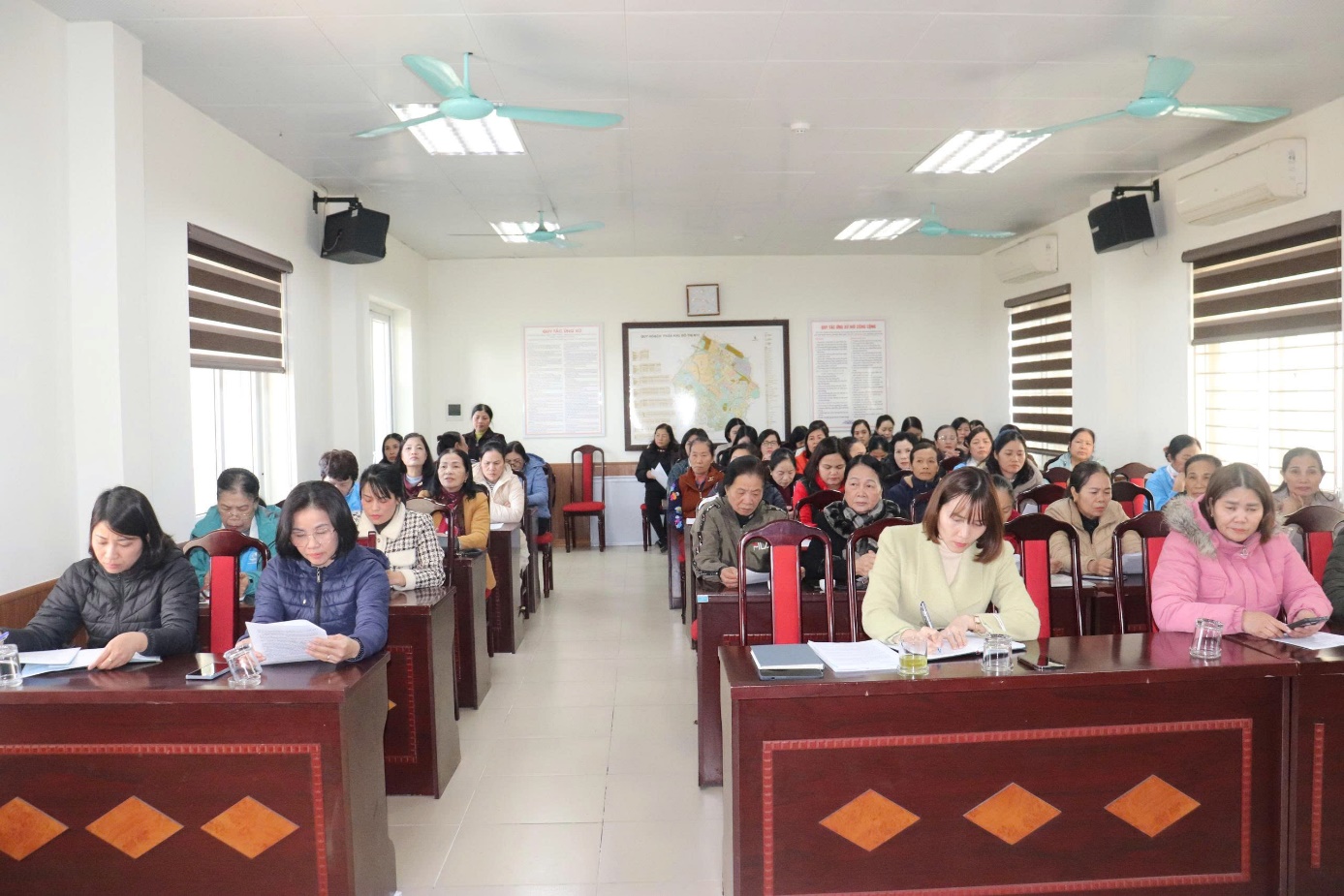 A group of people sitting in a room  AI-generated content may be incorrect.