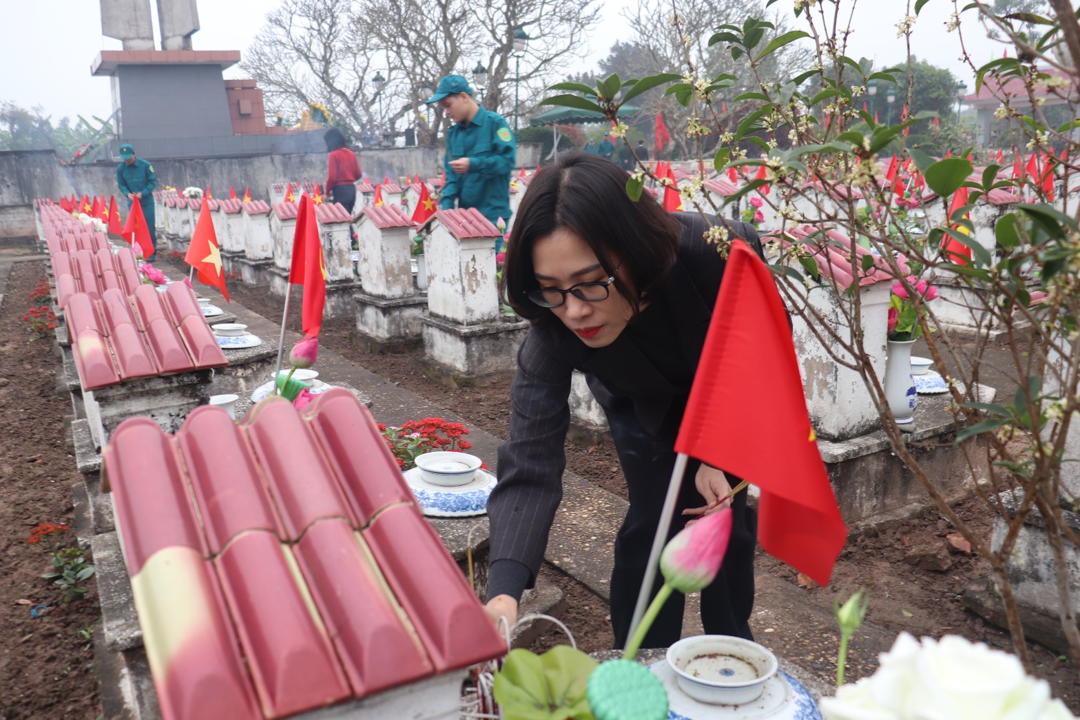 A person standing near a grave  AI-generated content may be incorrect.