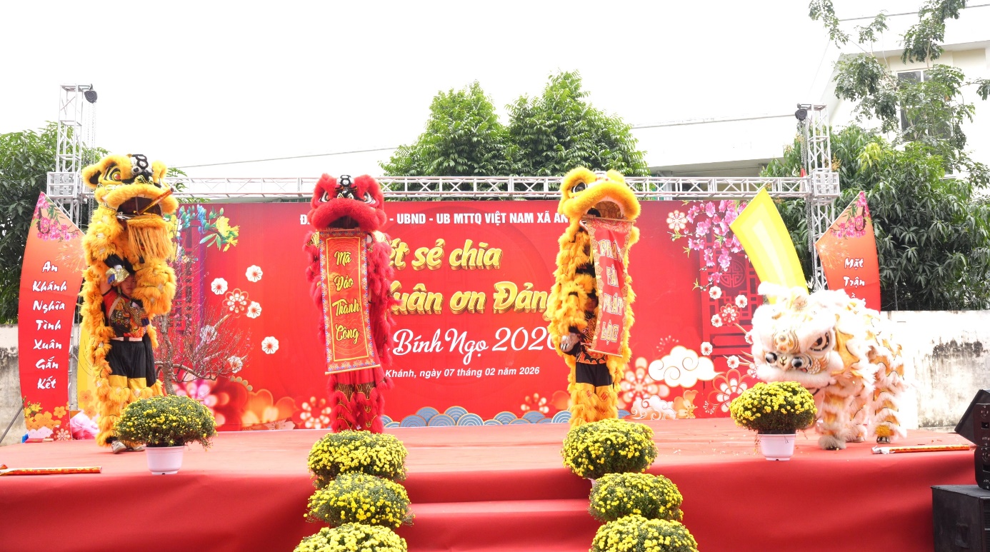 A stage with a red backdrop and a group of people on it  AI-generated content may be incorrect.