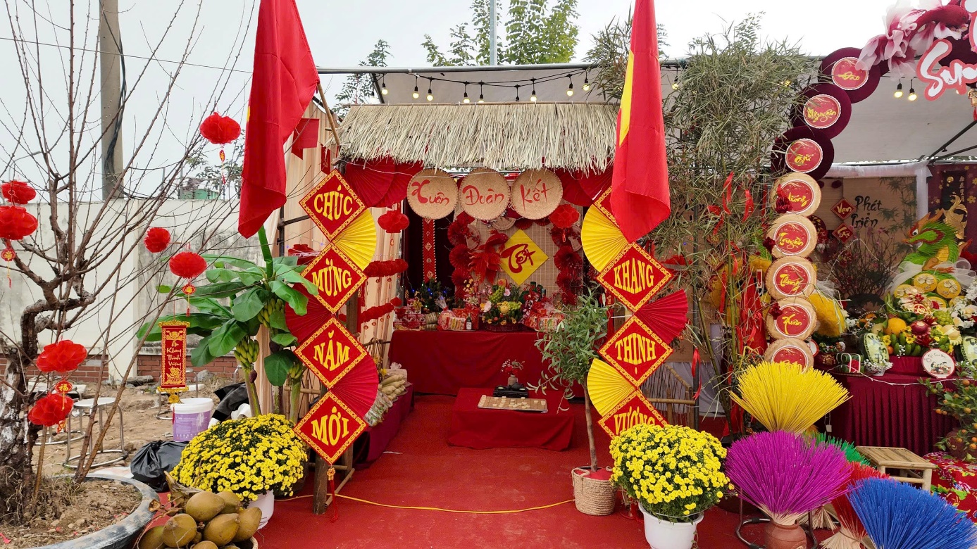 A small booth with red carpet and flags  AI-generated content may be incorrect.