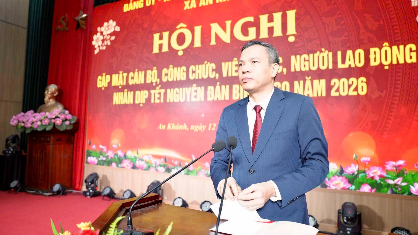 A person standing at a podium with microphones  AI-generated content may be incorrect.