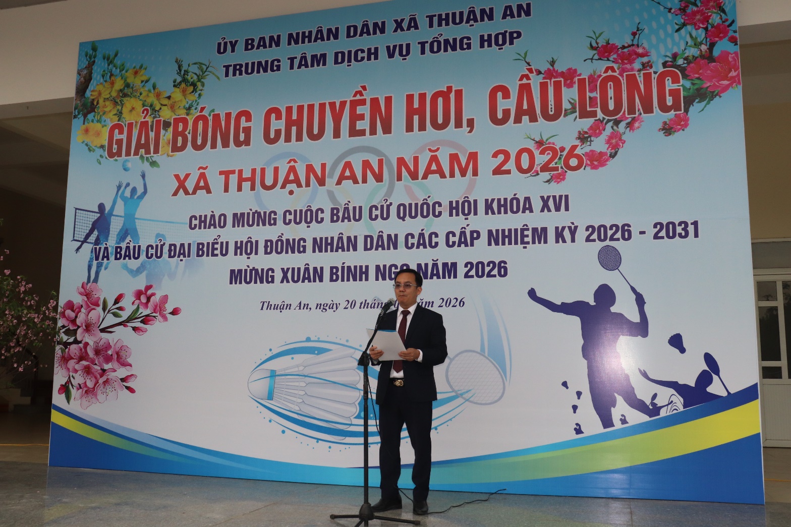 A person standing in front of a banner  AI-generated content may be incorrect.