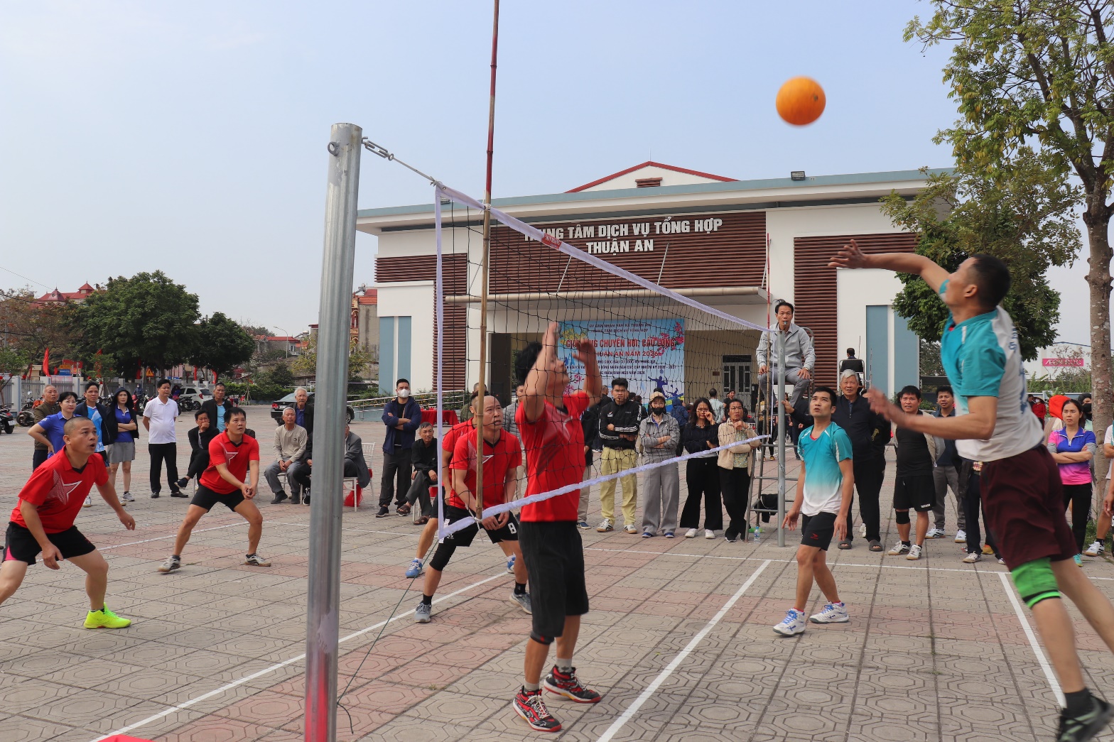 A group of people playing volleyball  AI-generated content may be incorrect.