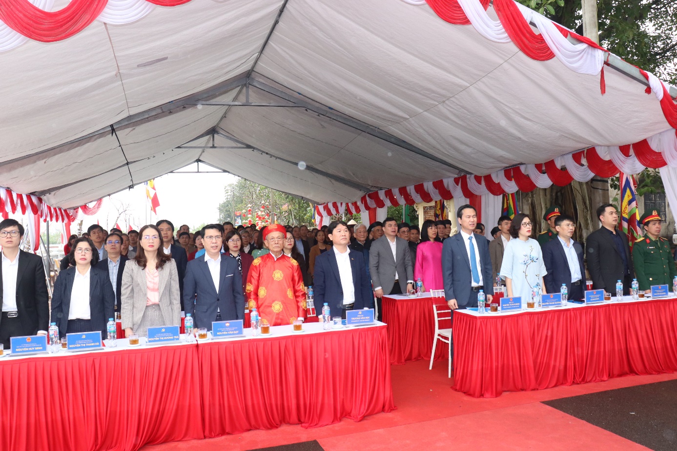 A group of people standing in a tent  AI-generated content may be incorrect.