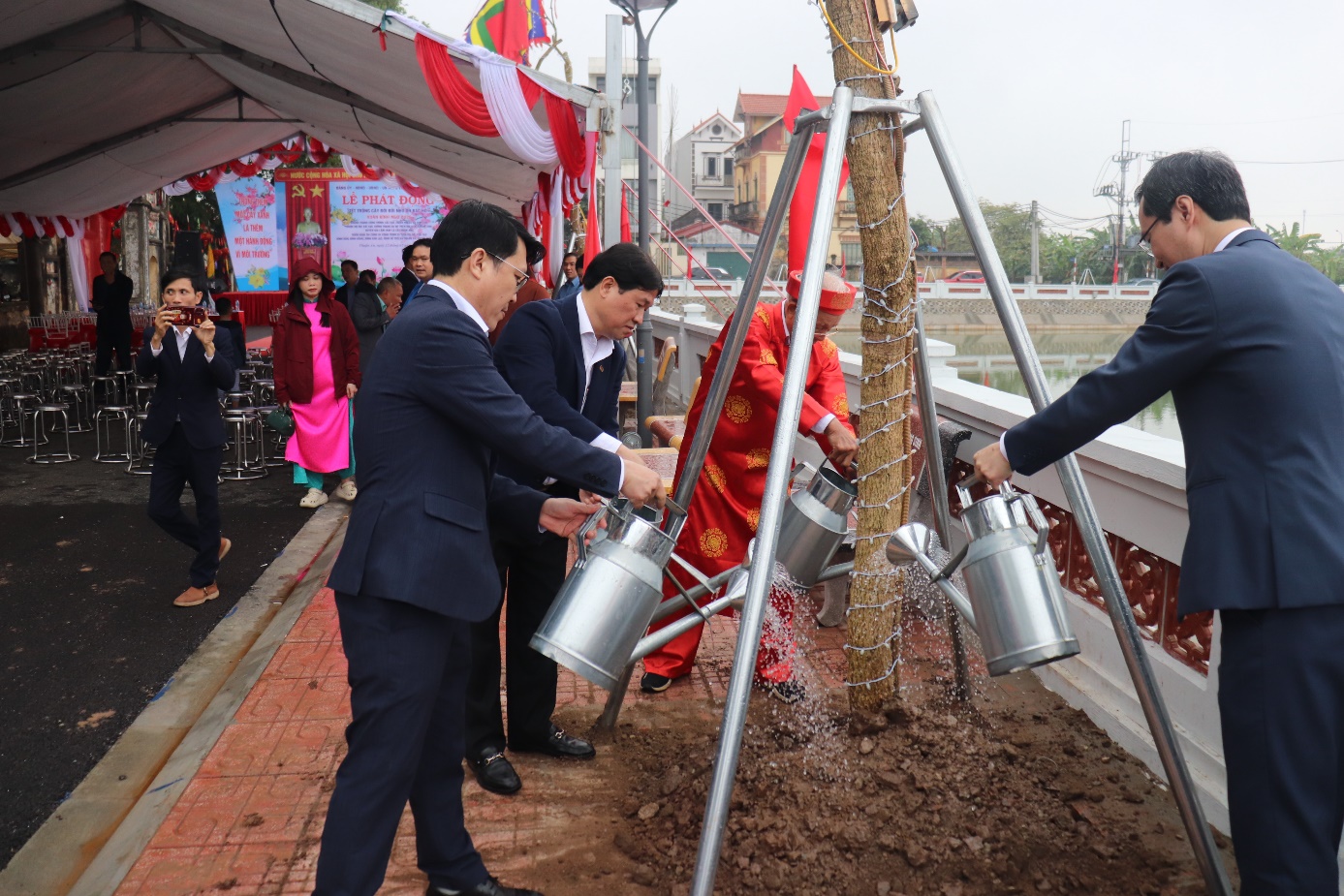 A group of men watering trees  AI-generated content may be incorrect.
