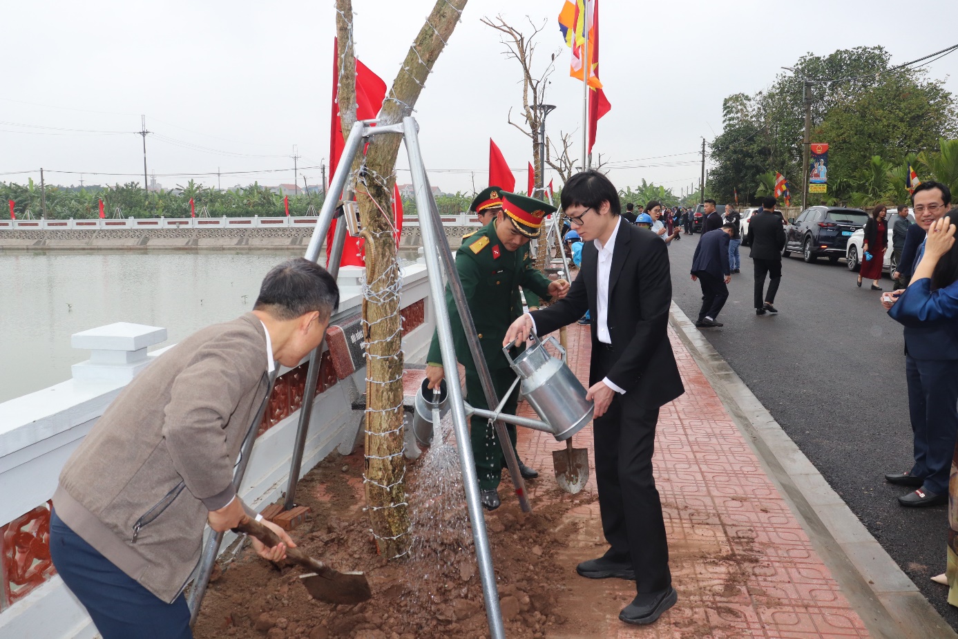 A group of men planting a tree  AI-generated content may be incorrect.