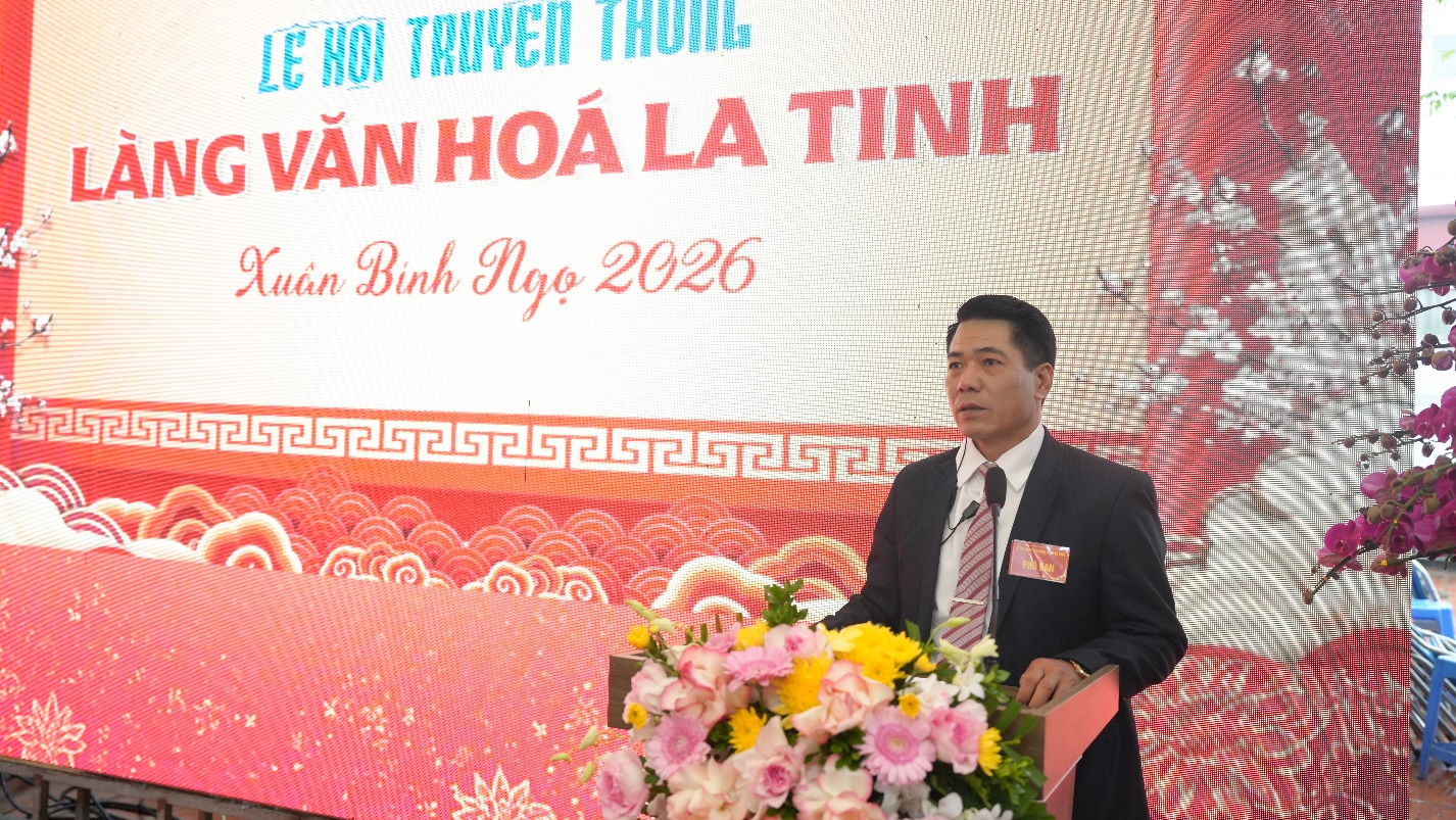 A person in a suit standing in front of a large screen  AI-generated content may be incorrect.