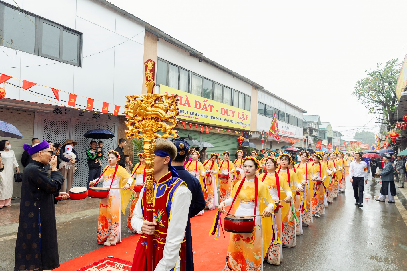A group of people in traditional clothing walking on a street  AI-generated content may be incorrect.