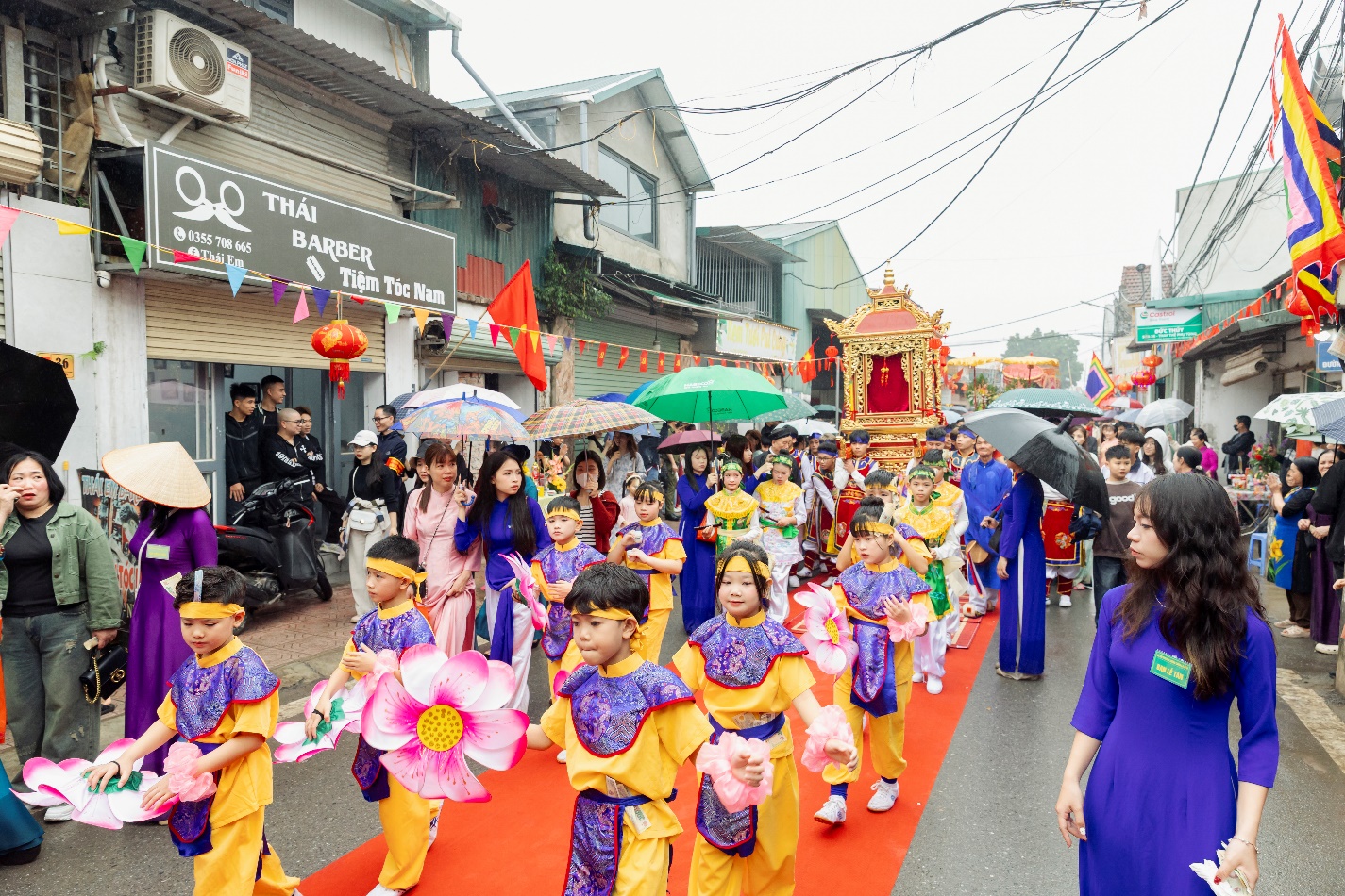 A group of people walking on a street with umbrellas  AI-generated content may be incorrect.