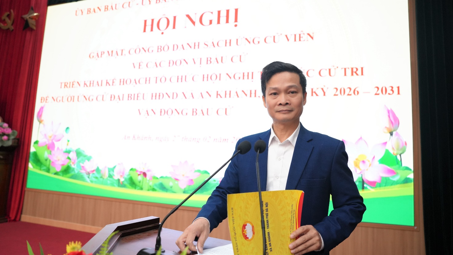 A person standing at a podium with microphones  AI-generated content may be incorrect.