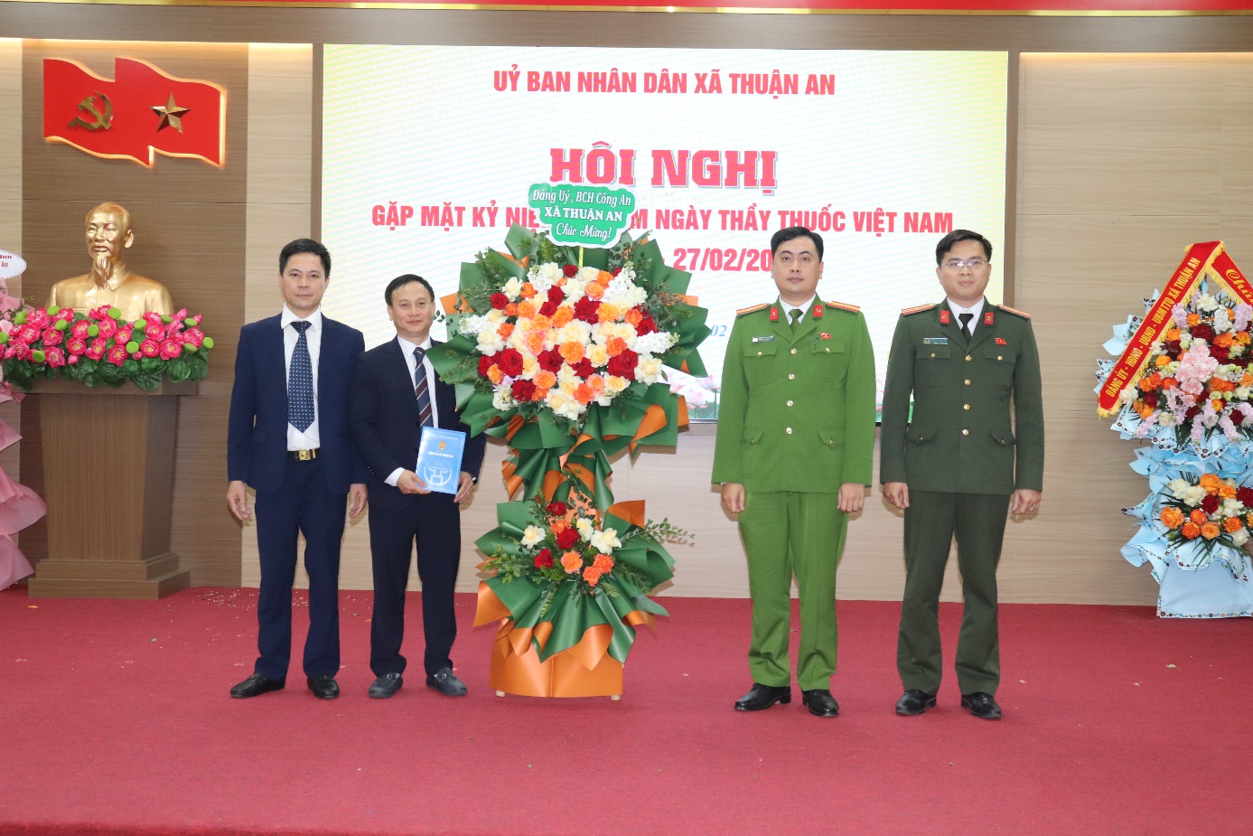 A group of men standing in front of a large flower arrangement  AI-generated content may be incorrect.