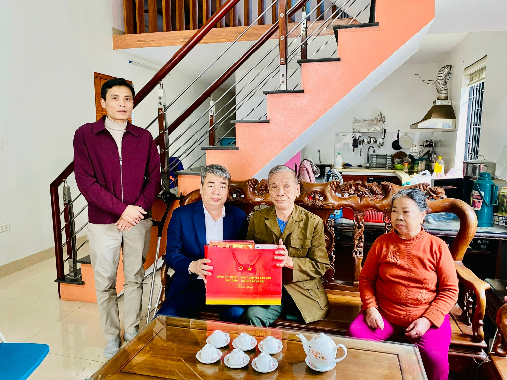 A group of people sitting on a bench  Description automatically generated