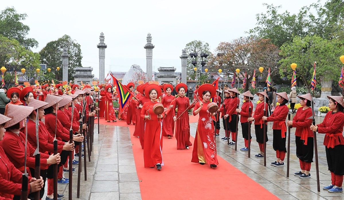 A group of people in red dresses walking on a red carpet  AI-generated content may be incorrect.