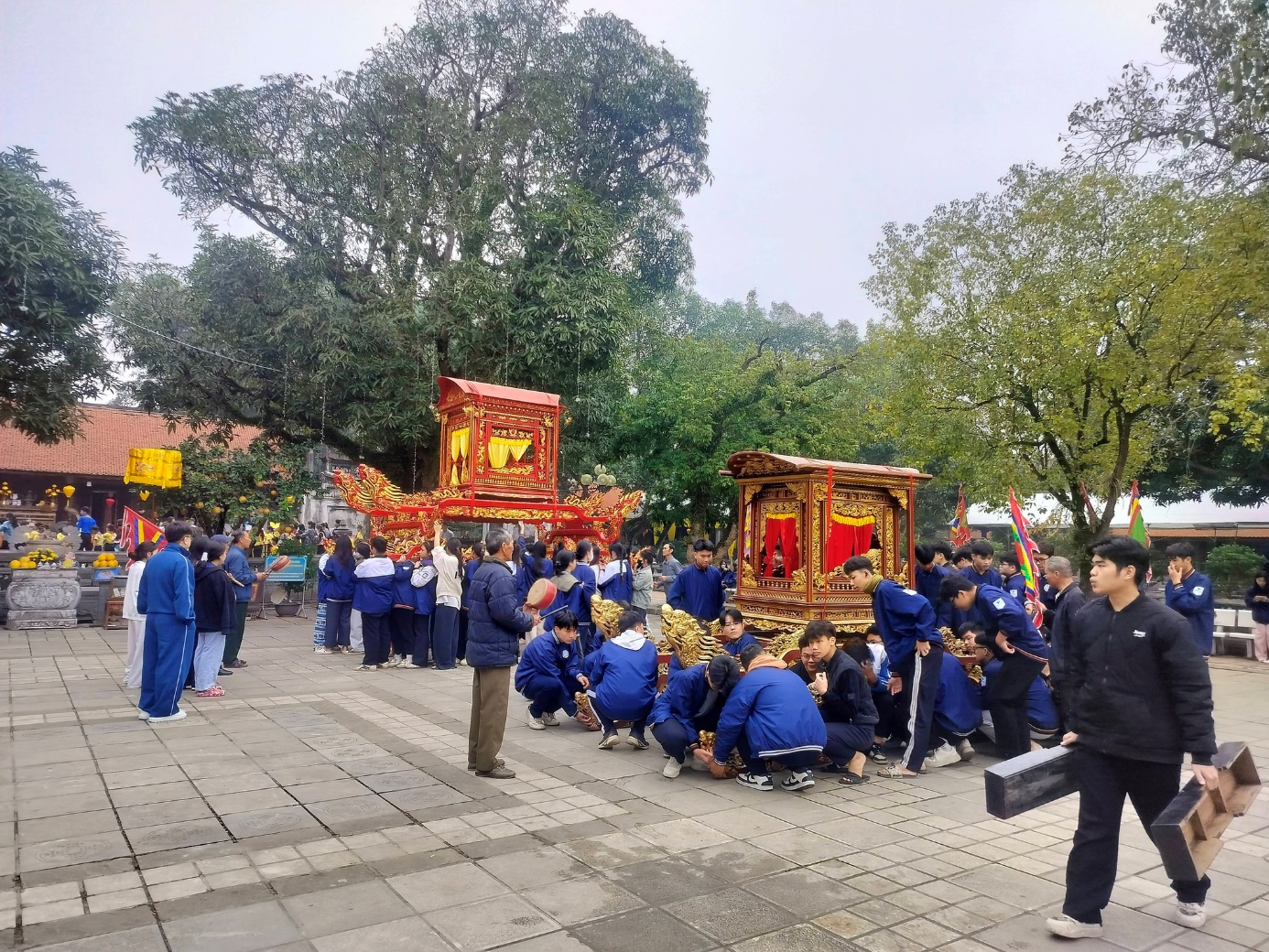 A group of people in blue uniforms kneeling in front of a large crowd  AI-generated content may be incorrect.